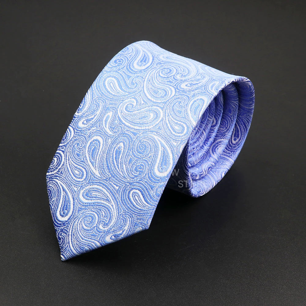 Blue paisley patterned tie on a black background