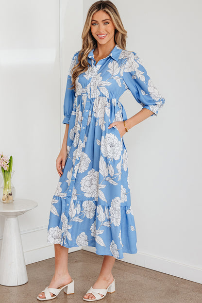 Robe longue bleu ciel à imprimé floral, col boutonné, manches 3/4 et ourlet à volants