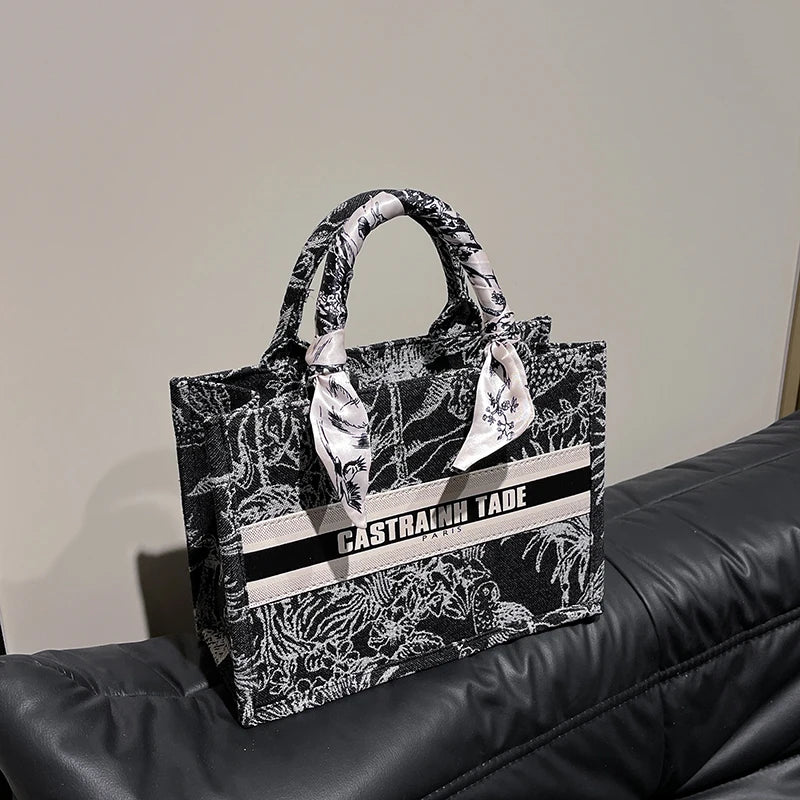 Black and white patterned bag with text on a black surface