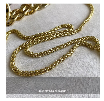 Gold chain on a textured white surface