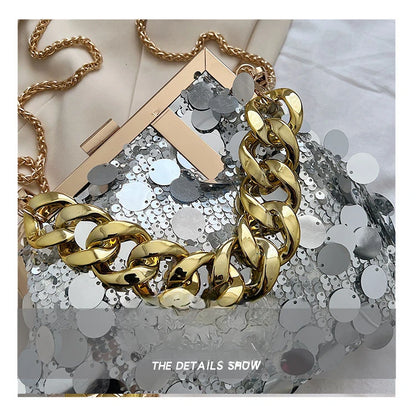 Gold chain necklace on a sequined surface with 'The Details Show' text.