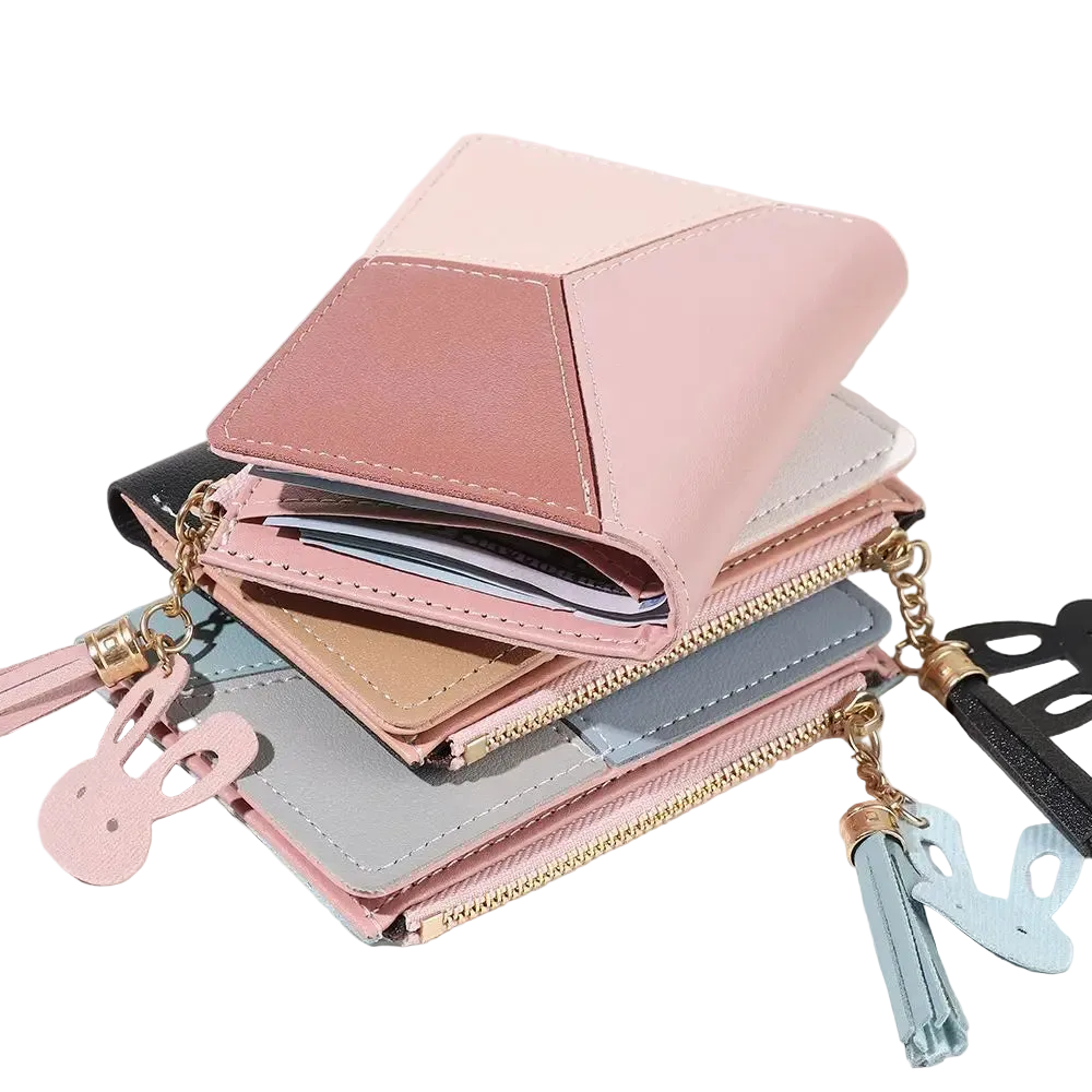 Pink wallet with tassel charm on a white background