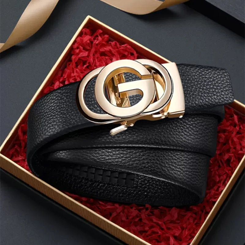 Black leather belt with gold buckle in a decorative box on a dark background