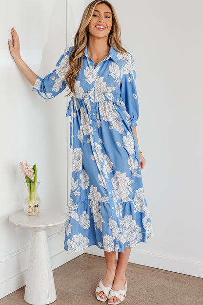 Robe longue bleu ciel à imprimé floral, col boutonné, manches 3/4 et ourlet à volants