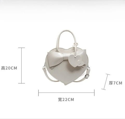 White carauana-lovely-shoulder-bag-heart with a bow and measurements.