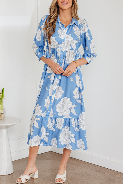 Robe longue bleu ciel à imprimé floral, col boutonné, manches 3/4 et ourlet à volants