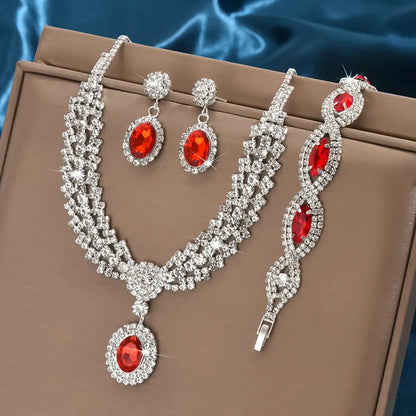 Jewelry set with red gemstones on a brown surface